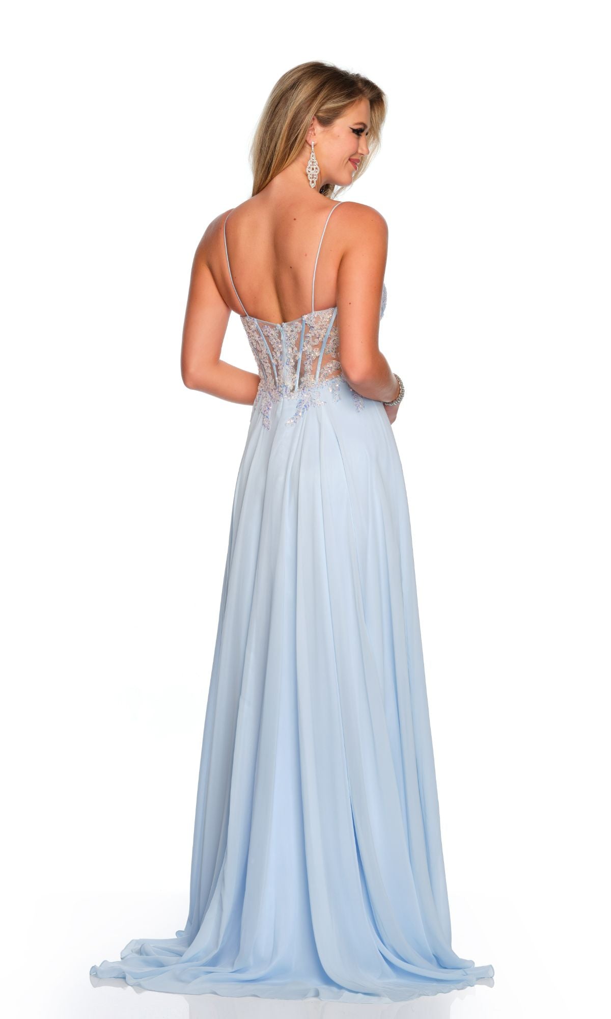 A woman stands looking over her shoulder, wearing the Long Formal Dress 11516 by Dave and Johnny in pastel ice blue with an embellished bodice and sheer back.